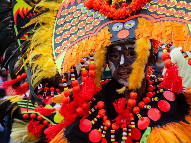 Vibrant and elaborate, participants of the Ati-Atihan Festival takes the streets of Kalibo, Aklan, Philippines
