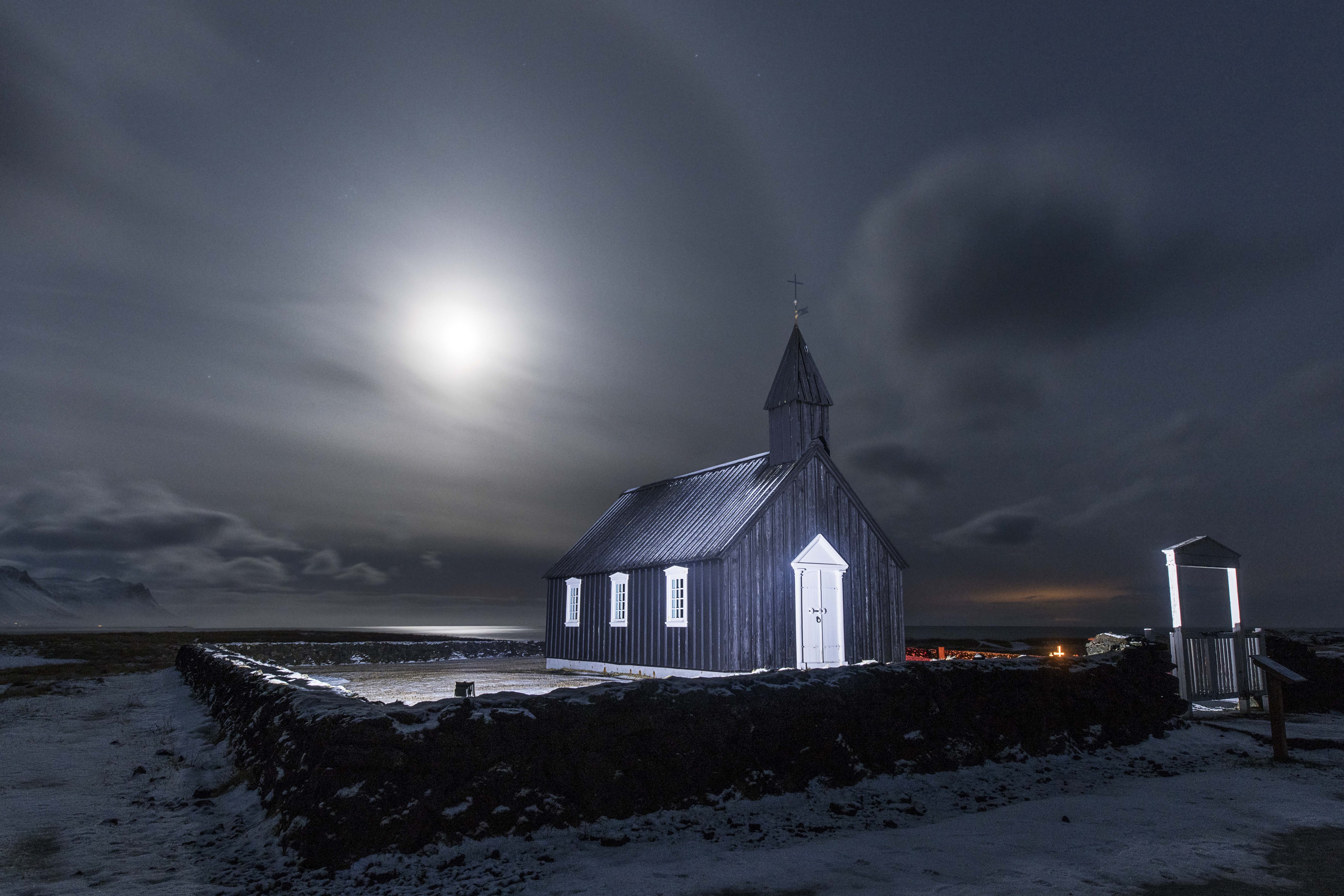 A bright moon shines on a cemetery in Iceland