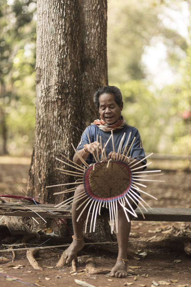 Alak tribesman making a hat in Bolaven
