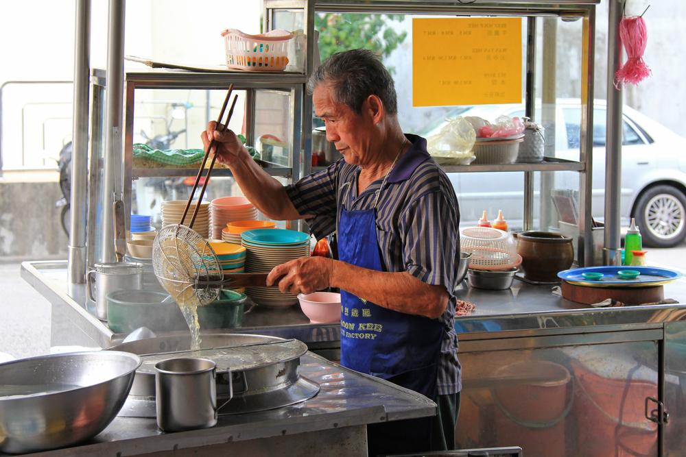 Uncle selling noodles at a hawker stall