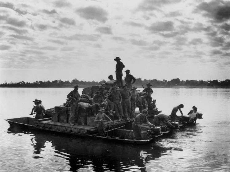 us Army bargepowered by outboard motors on the Irrawaddy River near Tigyiang Burma