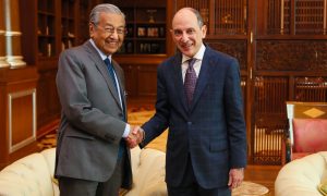 Akbar (right) shaking hands with Dr Mahathir to discuss issues of mutual interest