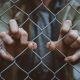 chain link fence and hands