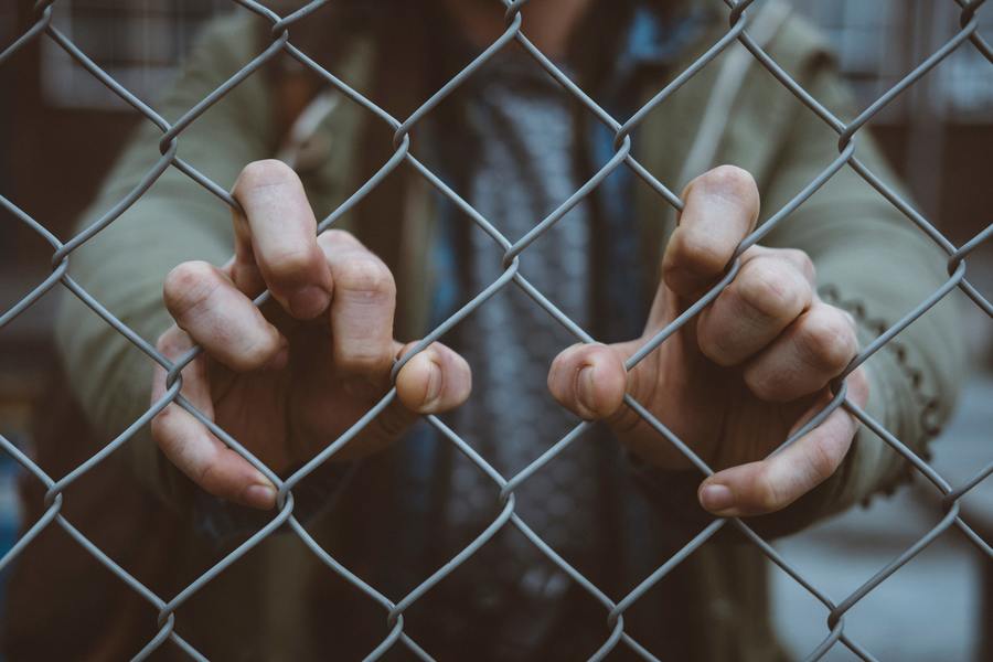 chain link fence and hands