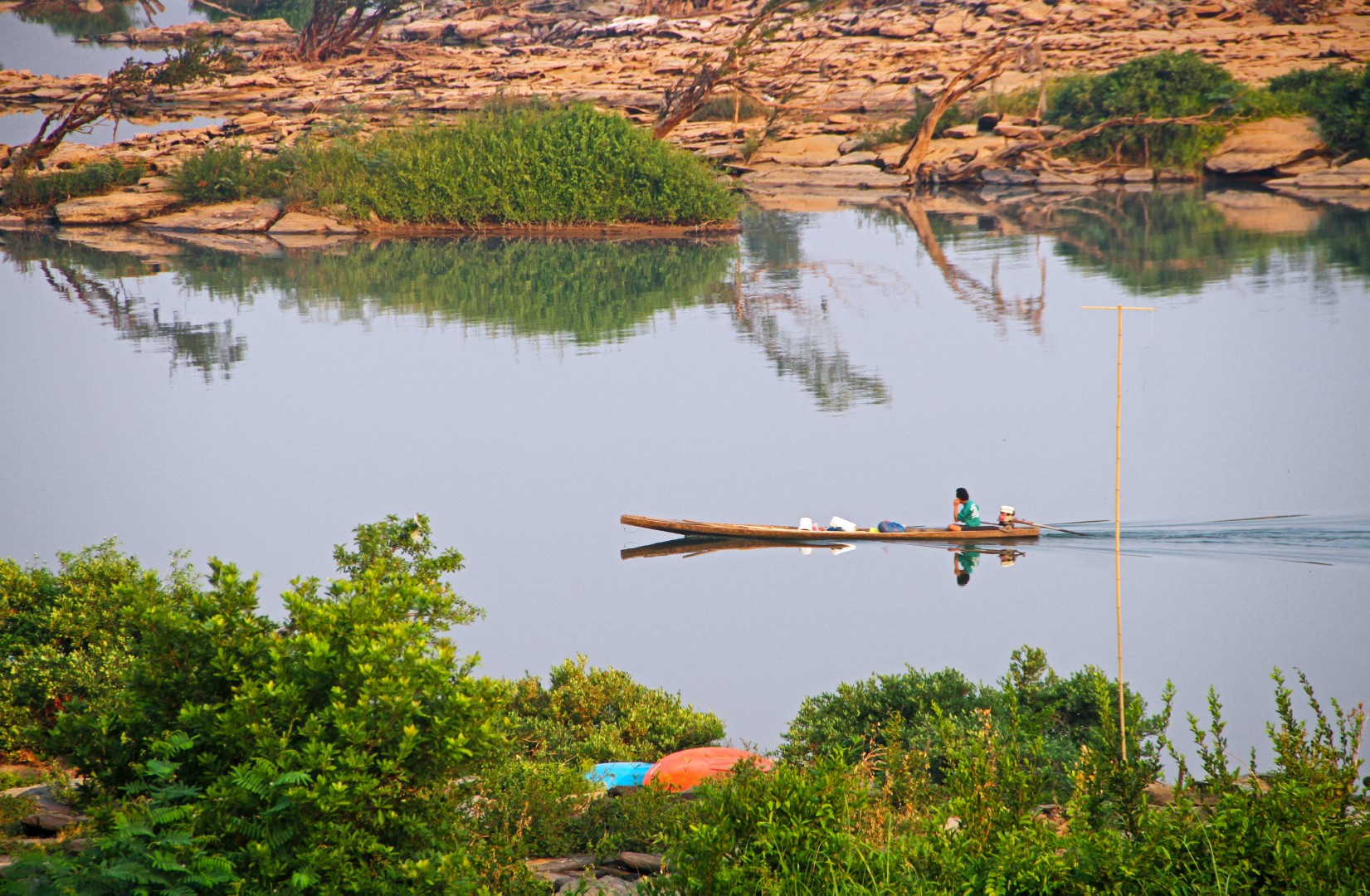 TH5 fishing boat on Mekong River in front of Tohsang Heritage Resort